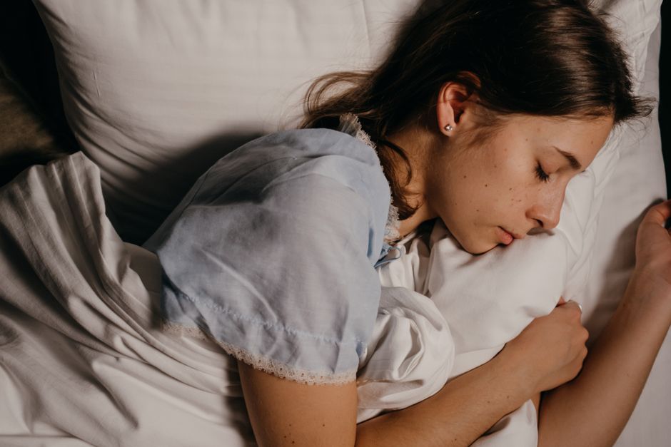 Adult sleeping peacefully under blanket