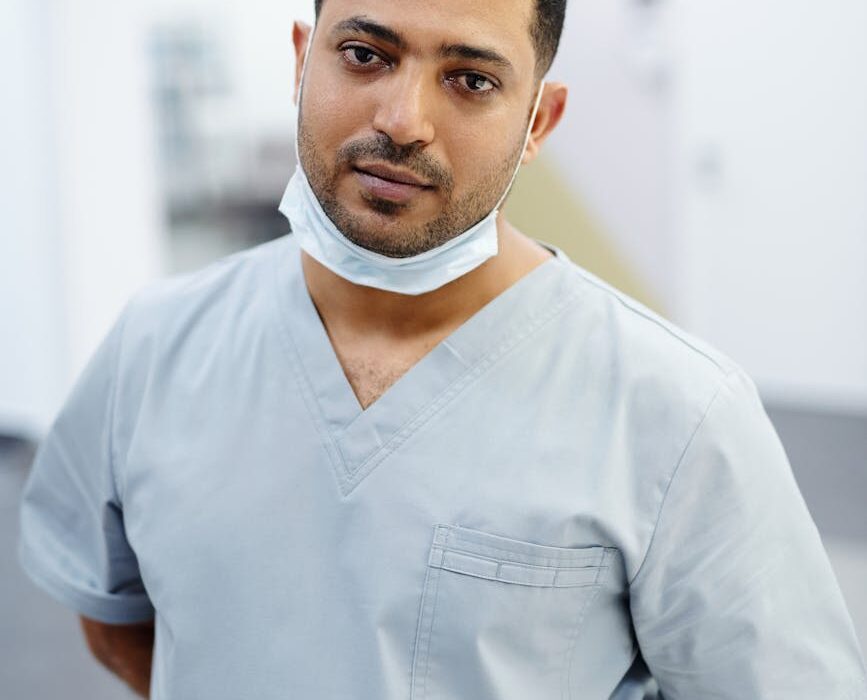 Dentist examining a patient's teeth during preparation for amalgam filling removal in a clinical setting