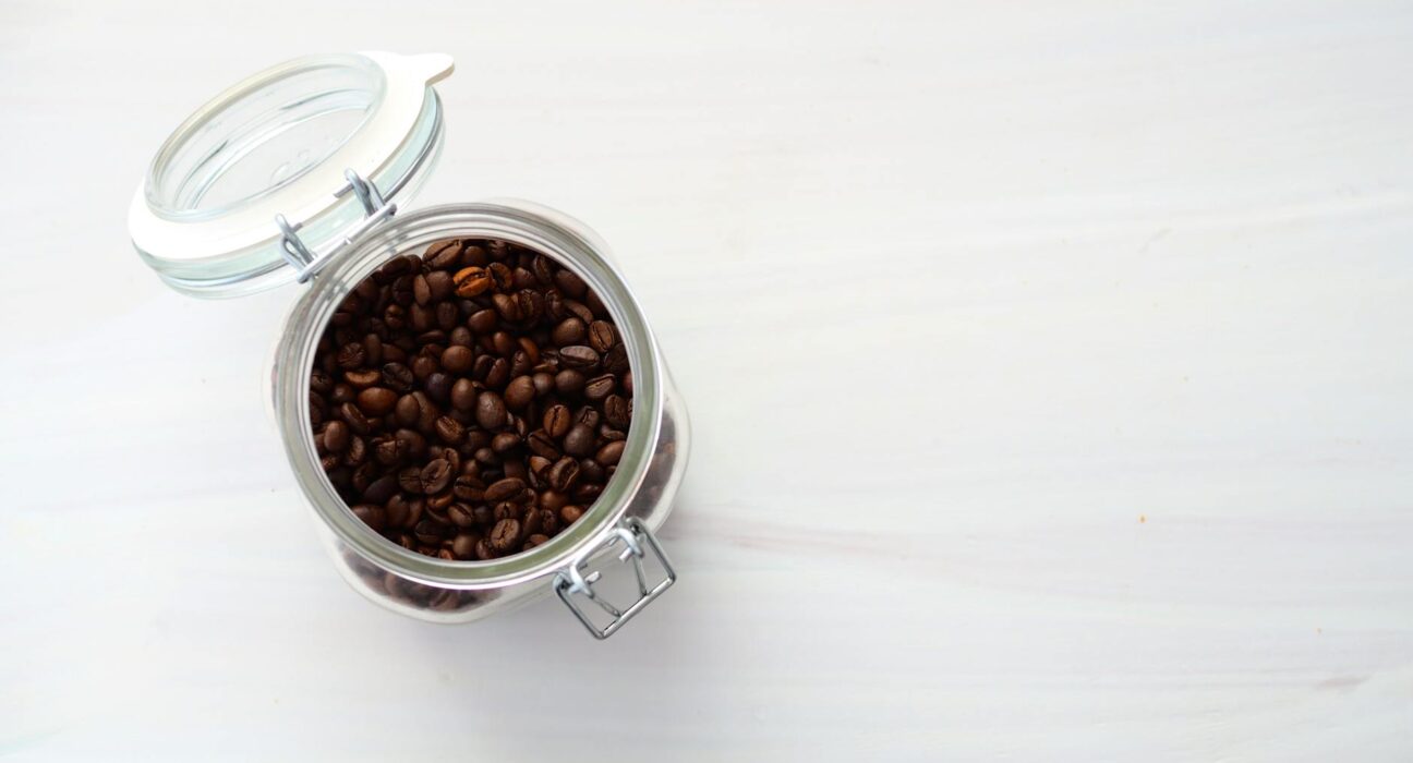 Glass jar of organic roasted coffee beans, the essential ingredient for a coffee enema