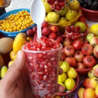 A small dish of colorful gummy vitamins on a wooden background